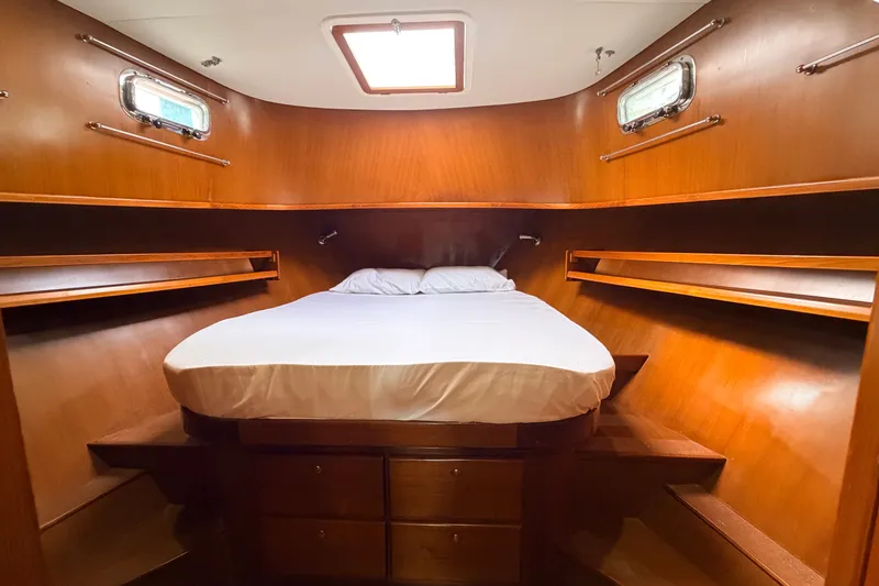 Slide: The Image of Cozy cabin interior of 2005 North Pacific 42 yacht with wooden finish and bed. - 32