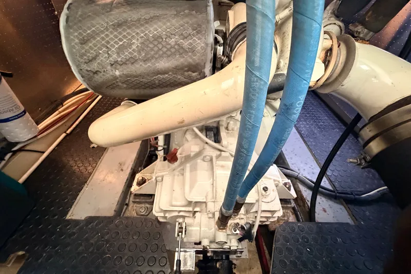 Slide: The Image of Engine room of a 2005 North Pacific 42 boat, featuring mechanical components and hoses. - 59