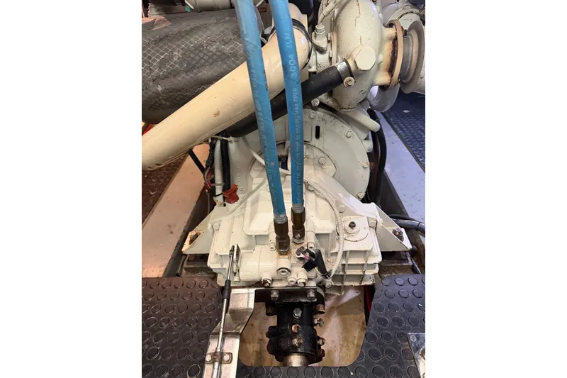 Slide: The Image of Engine compartment of a 2005 North Pacific 42 boat, showcasing mechanical components and hoses. - 62