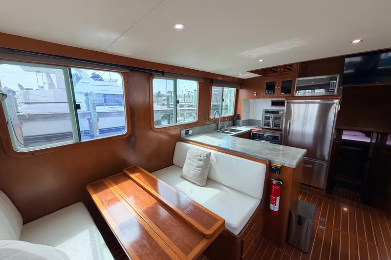 Slide: The Image of Interior of 2005 North Pacific 42 yacht with modern kitchen and dining area. - 16