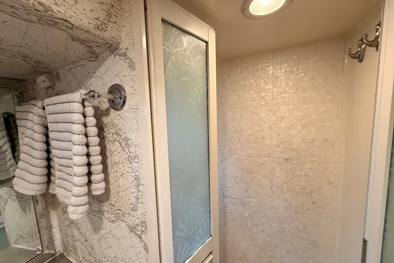 Slide: The Image of Luxurious bathroom in 2005 North Pacific 42 yacht with elegant tiled shower and towel rack. - 41