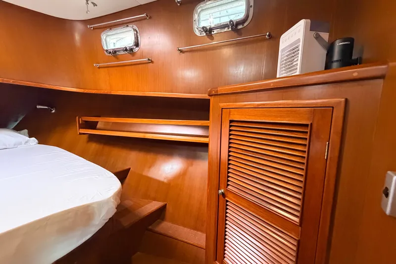 Slide: The Image of Cozy cabin interior of 2005 North Pacific 42 yacht with wooden furnishings and porthole windows. - 34