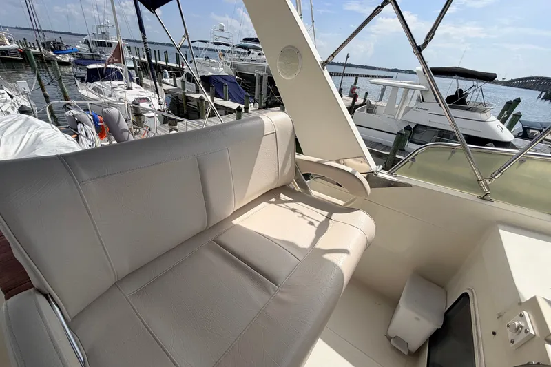 Slide: The Image of Flybridge seating on a 2005 North Pacific 42 yacht, docked at a marina. - 46