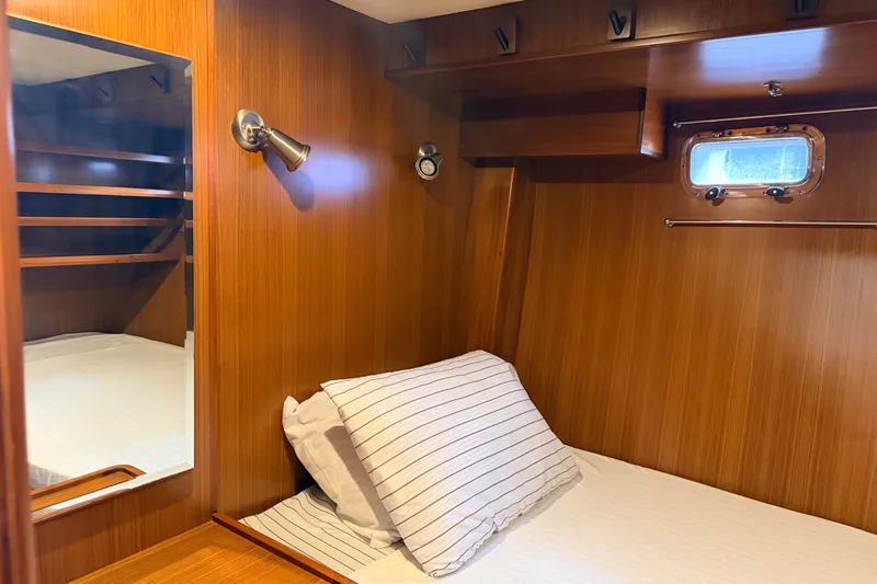 Slide: The Image of Cozy cabin interior of 2005 North Pacific 42 yacht with wooden paneling and bedding. - 37