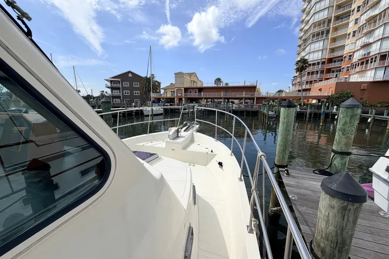 Slide: The Image of 2005 North Pacific 42 yacht docked at marina with waterfront buildings in background. - 50