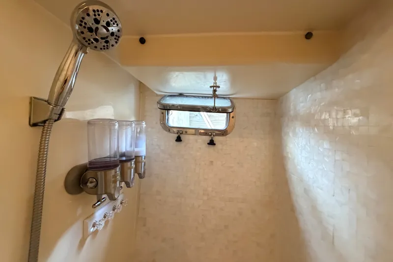 Slide: The Image of Shower area in 2005 North Pacific 42 boat with dispensers and handheld showerhead. - 42