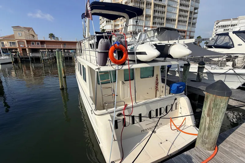 Slide: The Image of 2005 North Pacific 42 yacht docked at marina, featuring lifebuoy and inflatable boat. - 55
