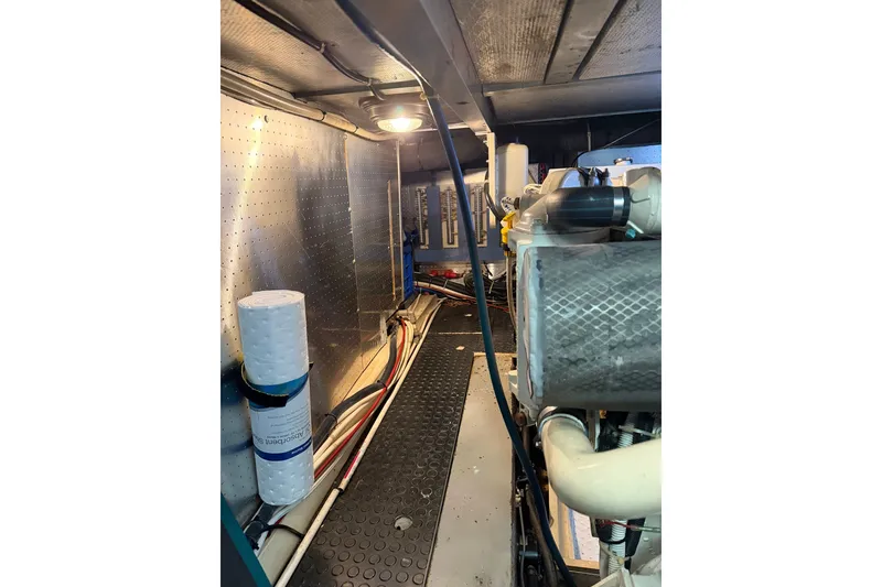 Slide: The Image of Engine room of a 2005 North Pacific 42 boat, showing machinery and wiring. - 66
