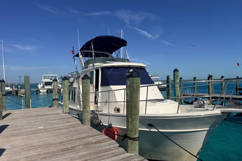Slide: The Image of 2005 North Pacific 42 yacht docked at a marina under clear blue skies. - 54