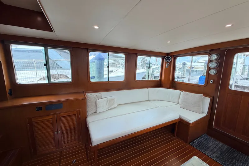 Slide: The Image of Interior of 2005 North Pacific 42 yacht with white seating and wooden accents. - 20