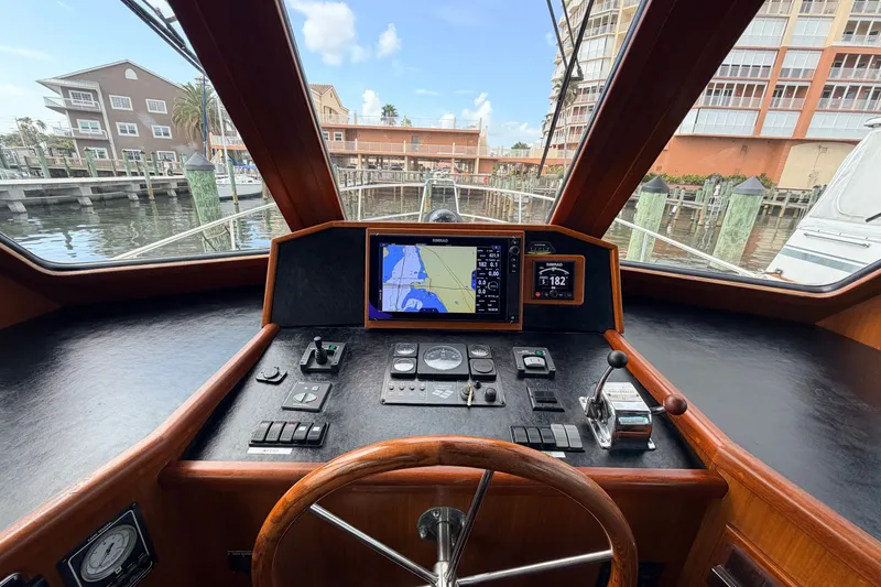 Slide: The Image of Helm of 2005 North Pacific 42 yacht with navigation equipment and waterfront view. - 28