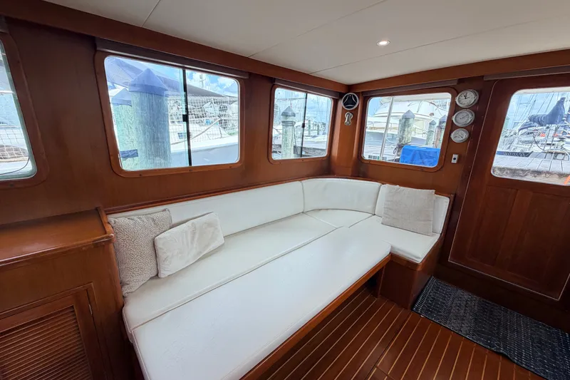 Slide: The Image of Luxurious interior of 2005 North Pacific 42 yacht with white seating and wooden accents. - 21