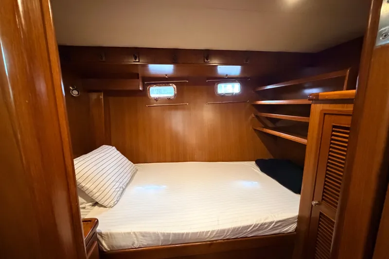Slide: The Image of Cozy cabin interior of 2005 North Pacific 42 yacht with wooden finish and comfortable bed. - 36