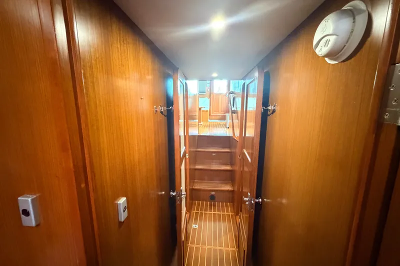 Slide: The Image of Interior hallway of 2005 North Pacific 42 yacht with wooden paneling and stairs. - 35