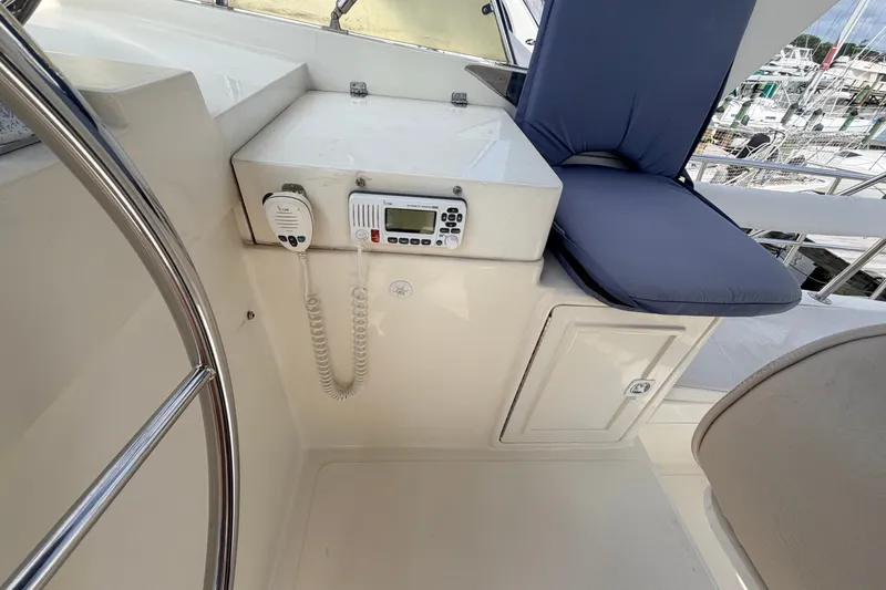Slide: The Image of Helm station of 2005 North Pacific 42 yacht with communication equipment and cushioned seating. - 47
