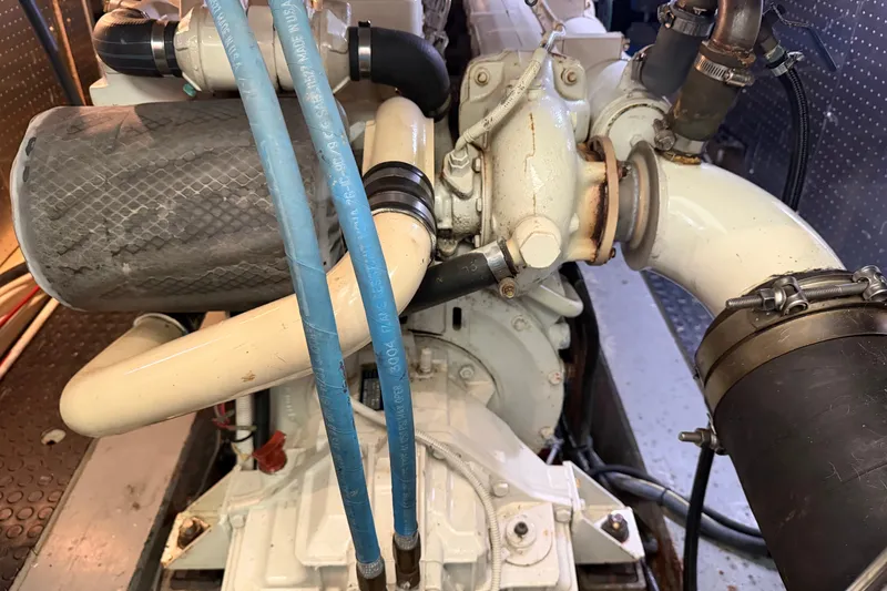 Slide: The Image of Engine compartment of a 2005 North Pacific 42 boat, featuring hoses and components. - 61