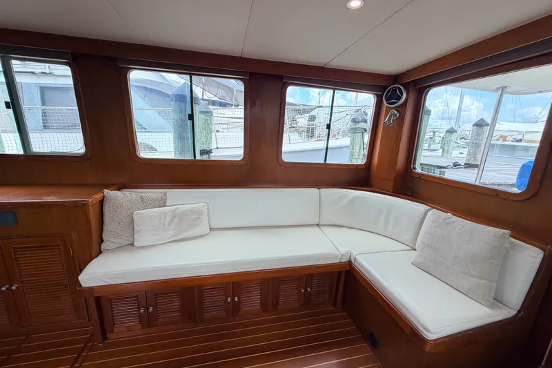 Slide: The Image of Luxurious interior of 2005 North Pacific 42 yacht with white cushioned seating. - 19