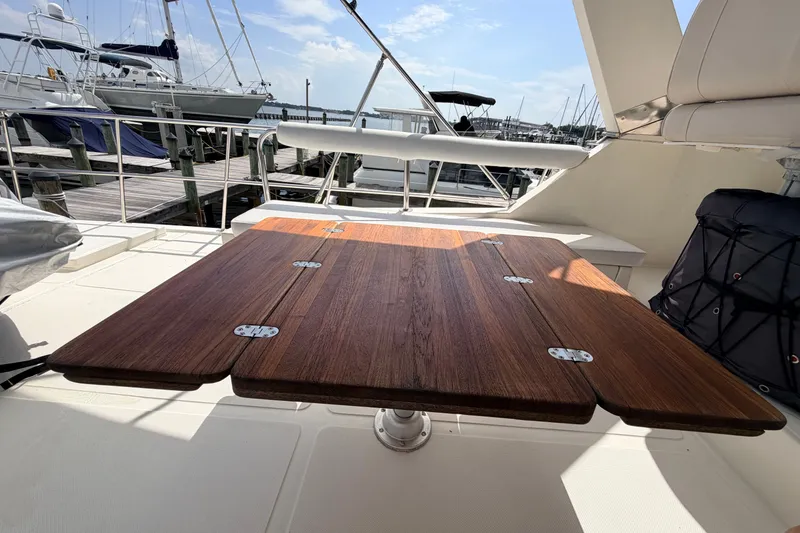 Slide: The Image of Wooden table on 2005 North Pacific 42 yacht deck, marina background. - 48