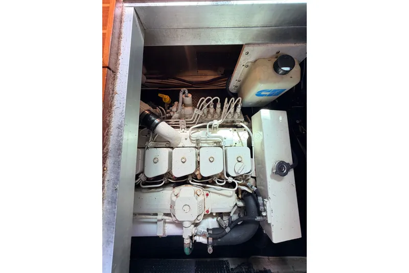 Slide: The Image of Engine compartment of a 2005 North Pacific 42 boat, showcasing mechanical components. - 56