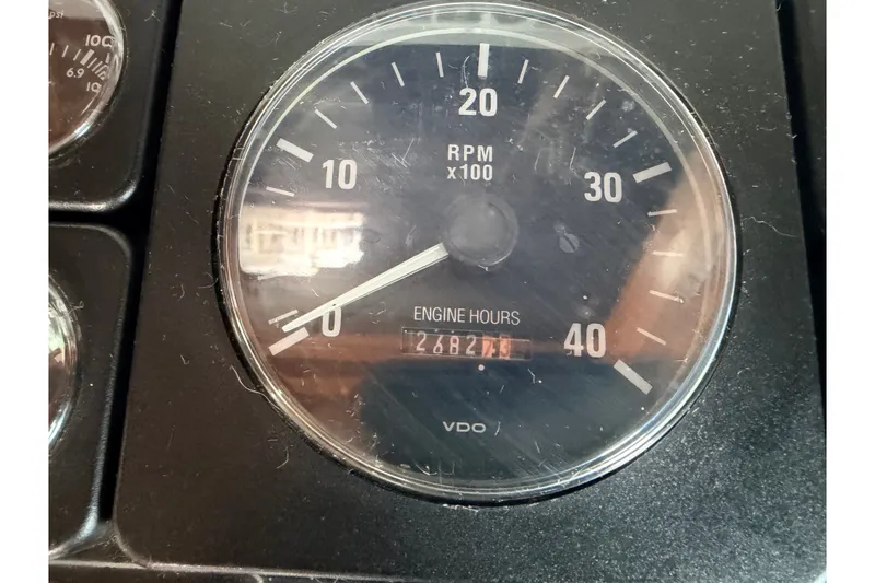 Slide: The Image of RPM gauge showing 2482.7 engine hours on North Pacific 42, 2005 model. - 29
