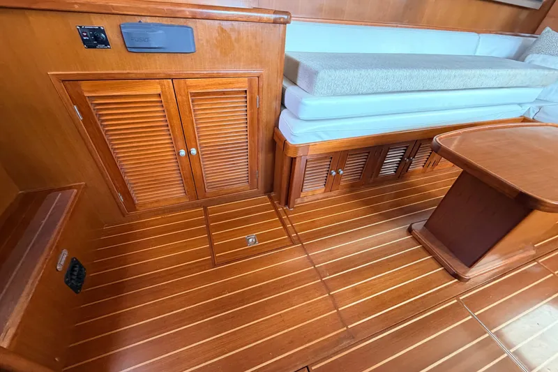 Slide: The Image of Interior of a 2005 North Pacific 42 boat with wooden flooring and seating area. - 23