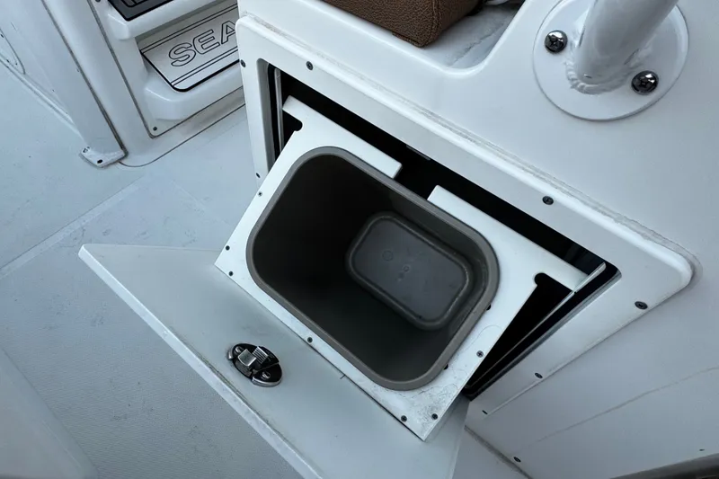 Slide: The Image of Storage compartment on a 2021 Sea Hunt Ultra 255SE boat, featuring an open hatch. - 14
