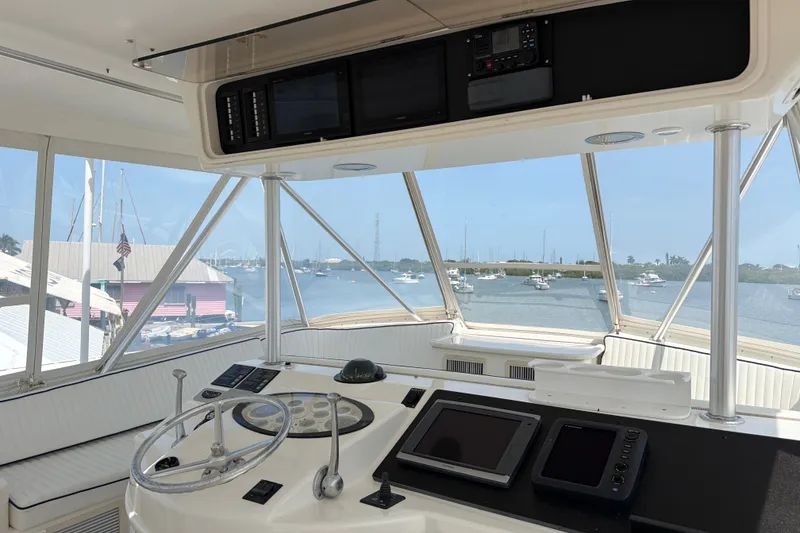 Slide: The Image of Cockpit view of 2002 Ocean Yachts 56 Super Sport with marina backdrop. - 42
