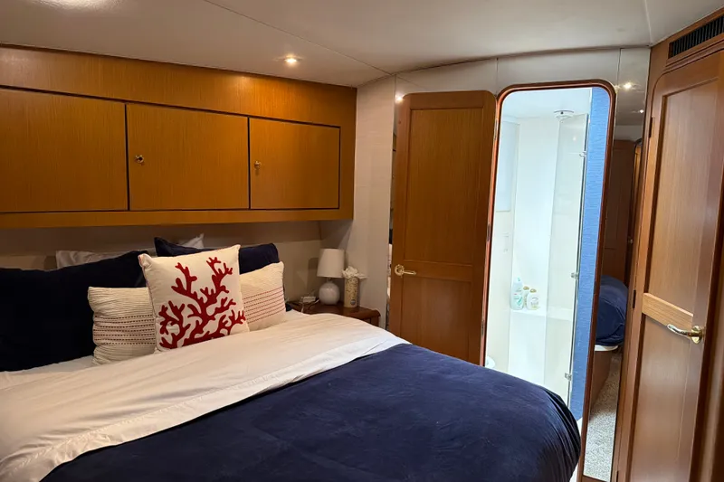 Slide: The Image of Luxurious bedroom interior of 2002 Ocean Yachts 56 Super Sport with elegant wood finishes. - 19
