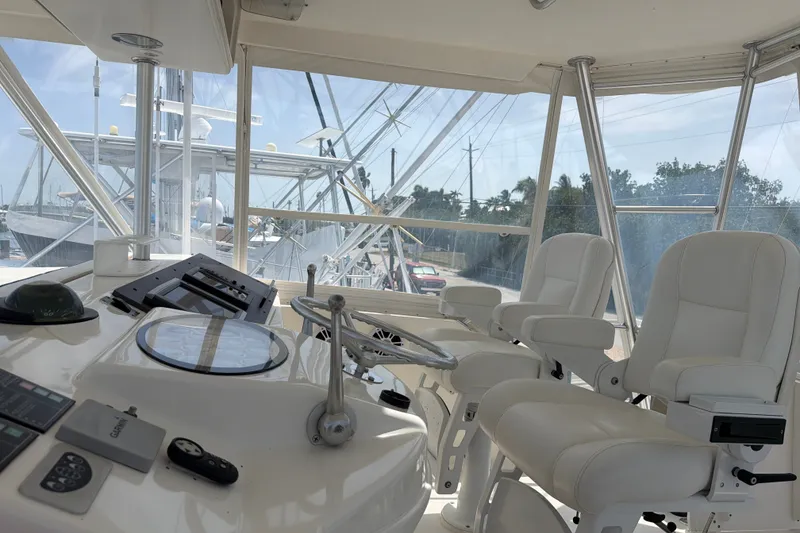 Slide: The Image of Helm of 2002 Ocean Yachts 56 Super Sport with white captain chairs and navigation controls. - 43