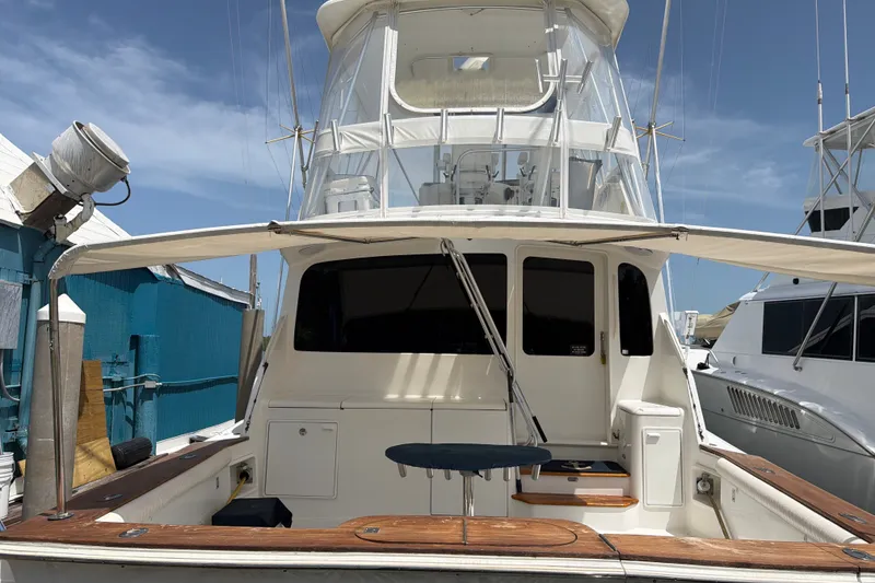Slide: The Image of 2002 Ocean Yachts 56 Super Sport boat docked, featuring spacious deck and flybridge. - 37