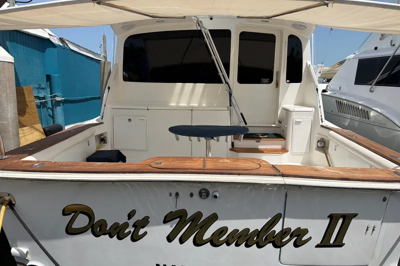 Slide: The Image of Ocean Yachts 2002 model 56 Super Sport boat docked, featuring "Don't Member II" name. - 36