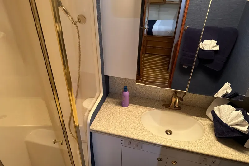 Slide: The Image of Luxurious bathroom in 2002 Ocean Yachts 56 Super Sport, featuring a shower and vanity sink. - 31