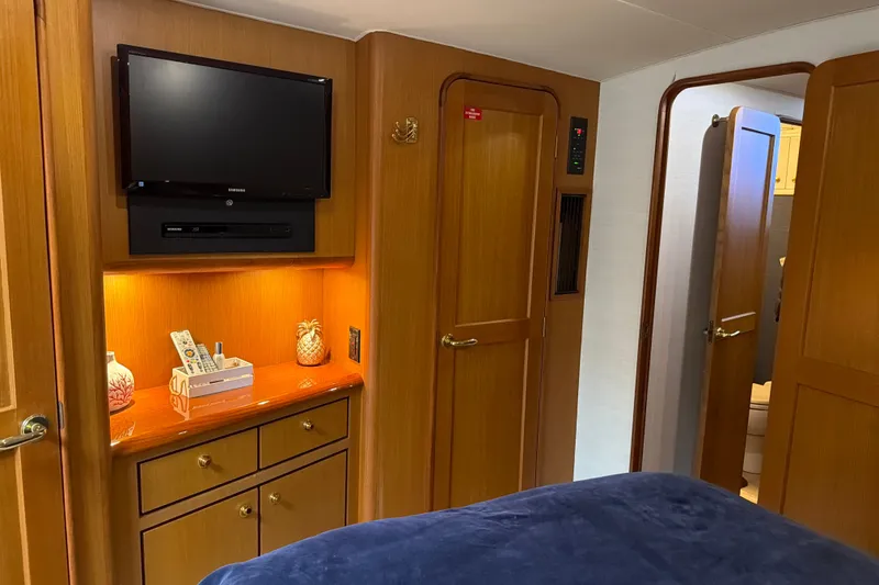 Slide: The Image of Luxurious interior of 2002 Ocean Yachts 56 Super Sport with TV and wooden cabinetry. - 21