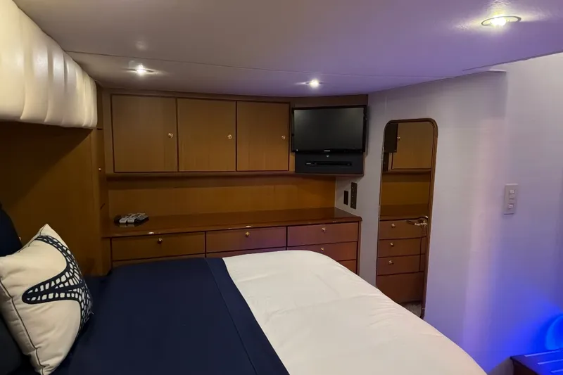 Slide: The Image of Luxurious cabin interior of 2002 Ocean Yachts 56 Super Sport with wood cabinetry and cozy bedding. - 22