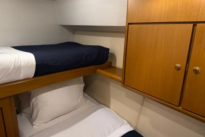 Slide: The Image of Interior cabin of 2002 Ocean Yachts 56 Super Sport with bunk beds and wooden cabinetry. - 25