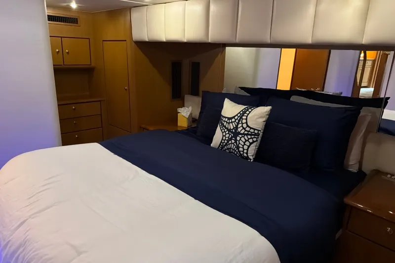 Slide: The Image of Luxurious bedroom interior of 2002 Ocean Yachts 56 Super Sport with elegant bedding and wood cabinetry. - 24