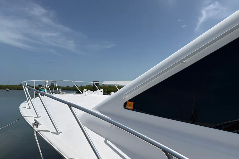 Slide: The Image of 2002 Ocean Yachts 56 Super Sport yacht docked, showcasing sleek design and railing. - 46