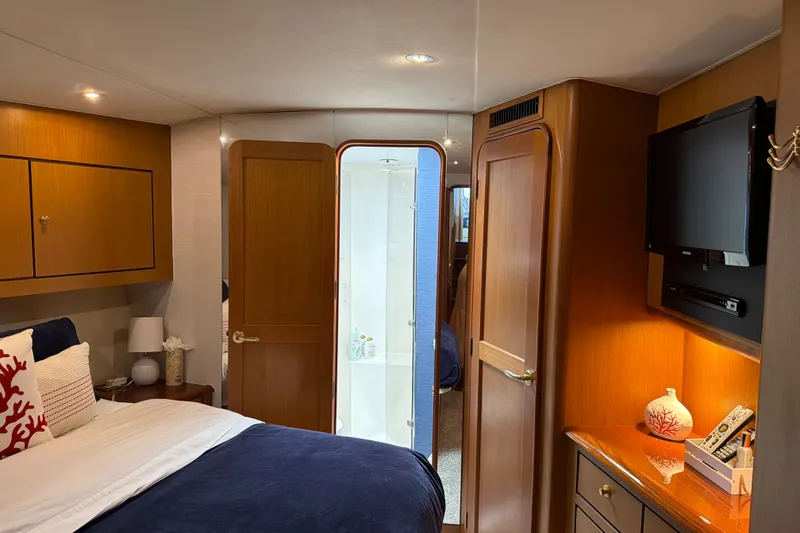 Slide: The Image of Luxurious cabin interior of 2002 Ocean Yachts 56 Super Sport with elegant wood finishes. - 20