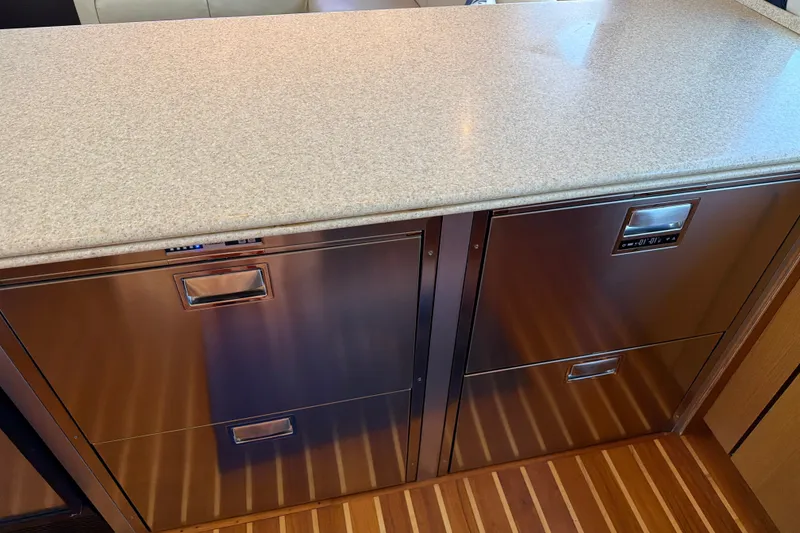 Slide: The Image of Stainless steel drawers in 2002 Ocean Yachts 56 Super Sport galley, with wood flooring. - 32