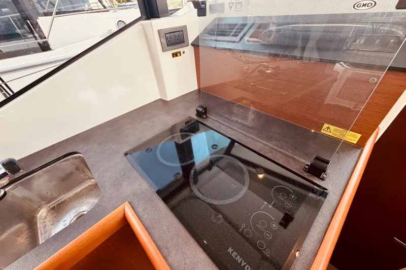 Slide: The Image of Modern kitchen area in 2019 Beneteau Swift Trawler 30 with sleek cooktop and sink. - 20
