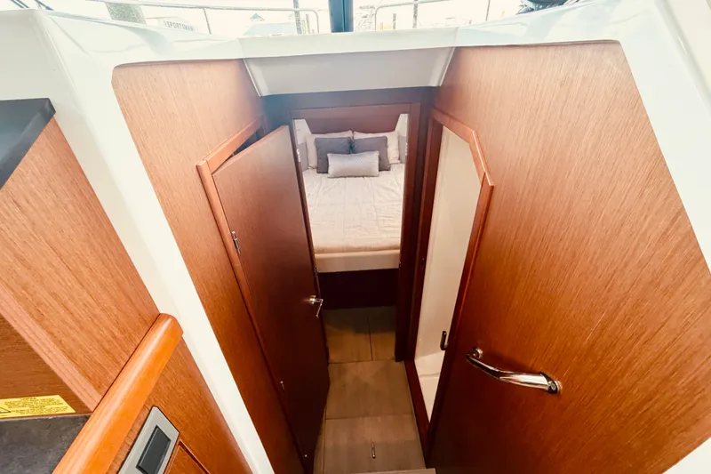Slide: The Image of Interior cabin view of a 2019 Beneteau Swift Trawler 30, featuring a cozy bedroom. - 24