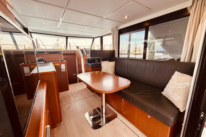 Slide: The Image of Interior of 2019 Beneteau Swift Trawler 30 with seating and helm station. - 13