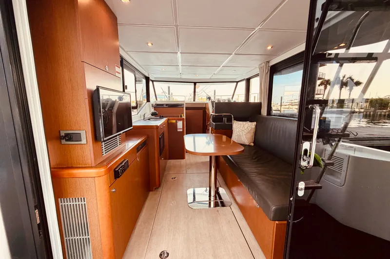 Slide: The Image of Interior of 2019 Beneteau Swift Trawler 30 with modern seating and wooden finishes. - 12