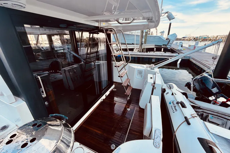 Slide: The Image of 2019 Beneteau Swift Trawler 30 docked, featuring a sleek deck and modern design. - 10