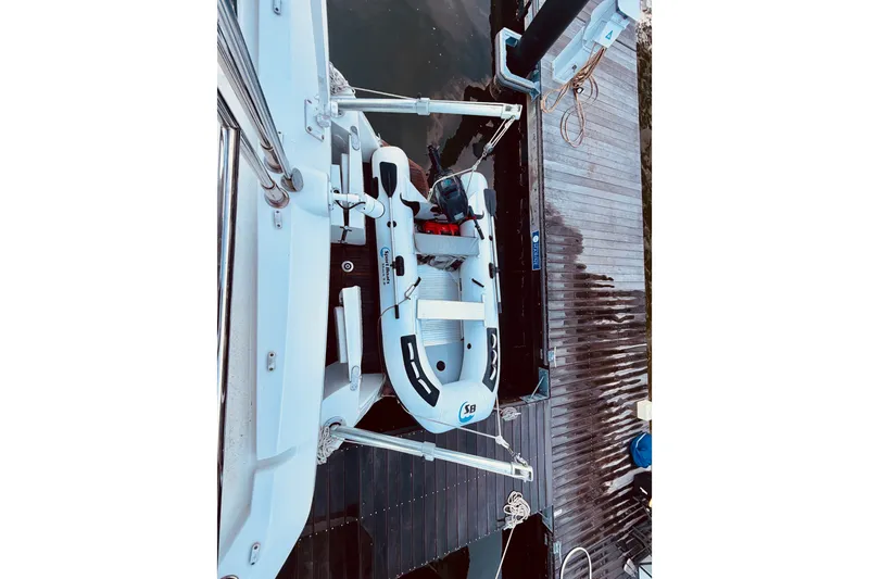 Slide: The Image of 2019 Beneteau Swift Trawler 30 docked with inflatable dinghy attached. - 9