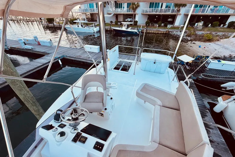 Slide: The Image of 2019 Beneteau Swift Trawler 30, featuring spacious deck and modern helm, docked at marina. - 6