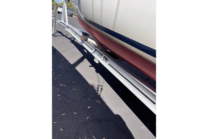 Slide: The Image of Boat trailer labeled "FLOAT-ON" supporting a Tattoo 26 model, 2014. - 24