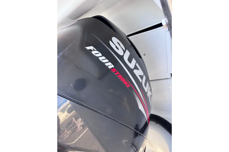 Slide: The Image of Suzuki Four Stroke outboard motor, black with red accents, model Tattoo 26, year 2014. - 21