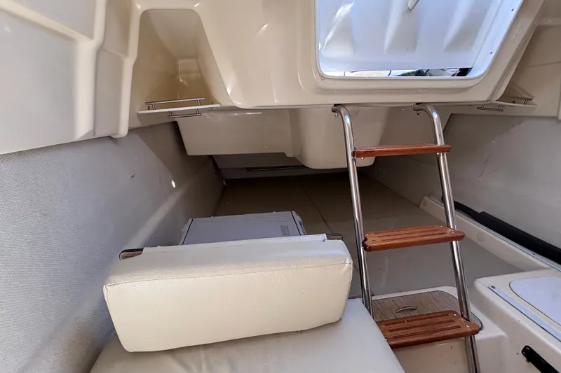 Slide: The Image of Interior cabin of a 2014 Tattoo 26 sailboat with ladder and seating. - 15