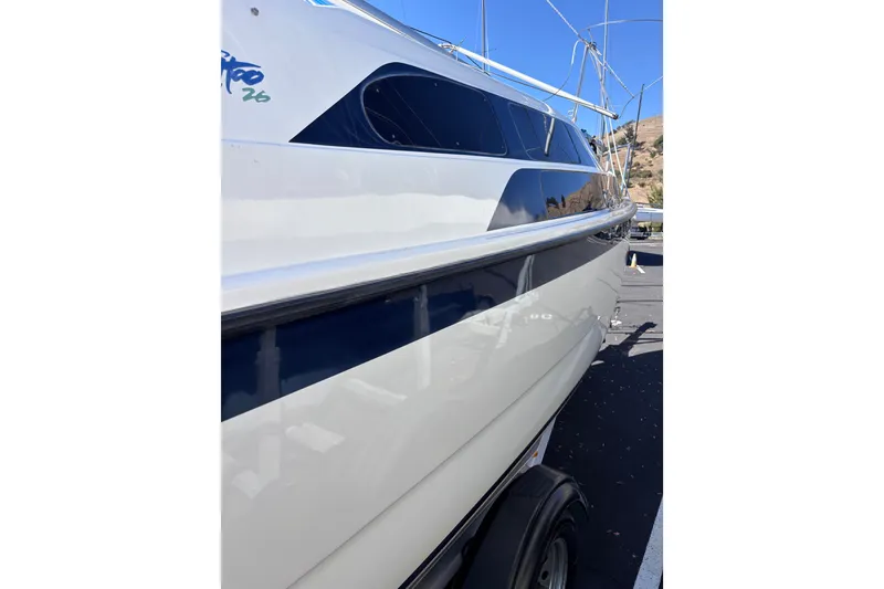 Slide: The Image of Tattoo 26 sailboat, 2014 model, side view with sleek design and blue accents. - 3